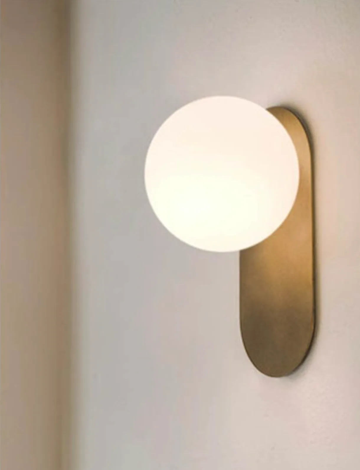 brass + opal glass wall sconce - lighting comparison blog